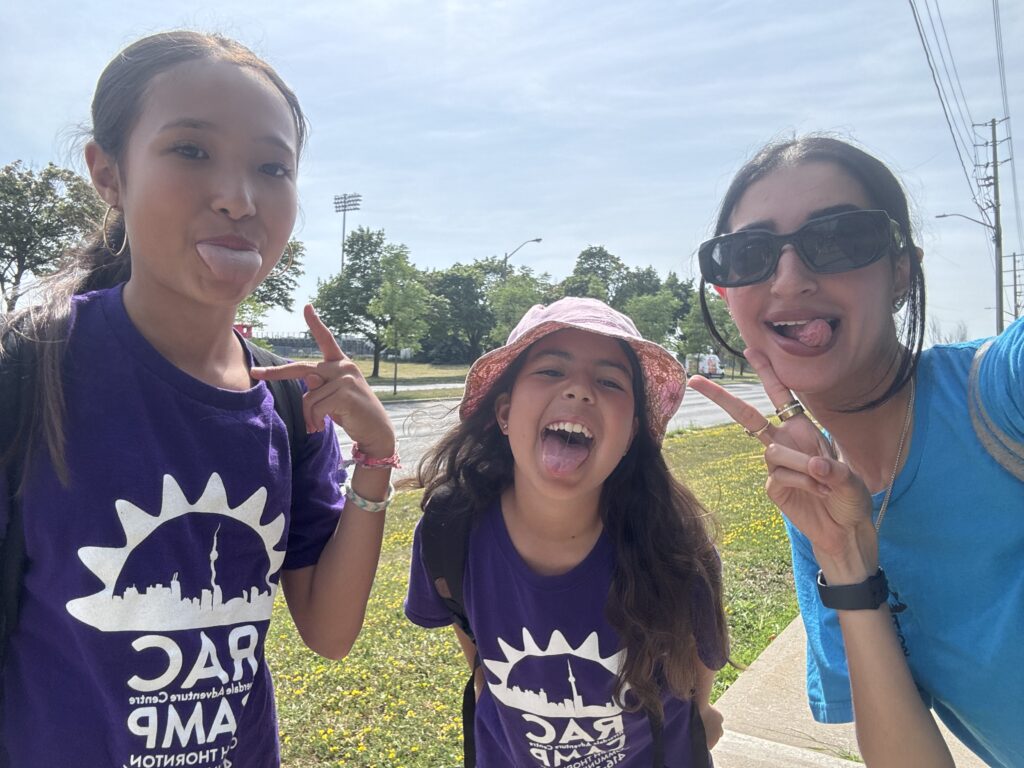 2 RAC Campers and one Staff member with their tongues out smiling.